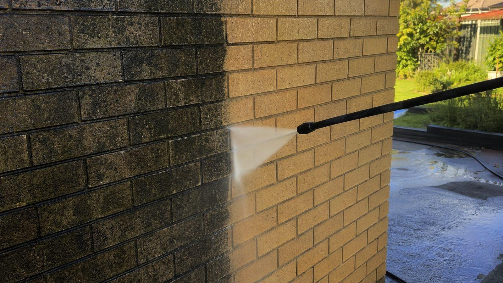 A brick house exterior being washed down