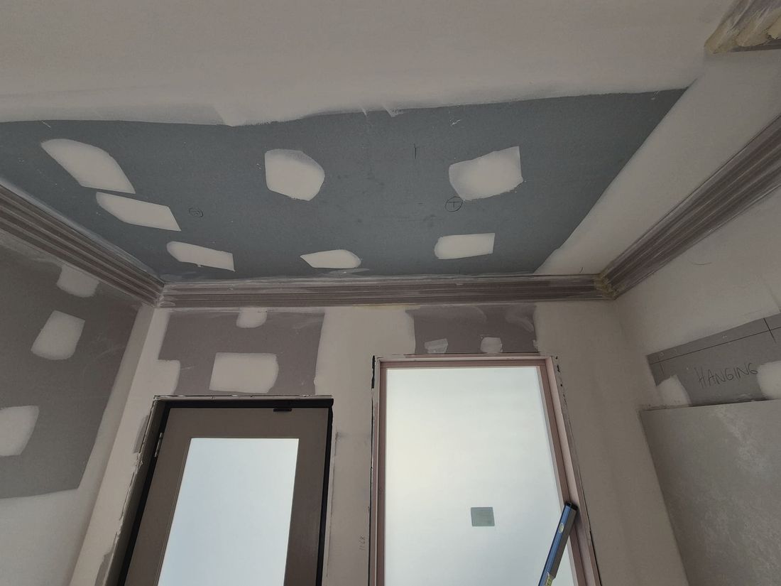 A patched ceiling and cornice run setting coated