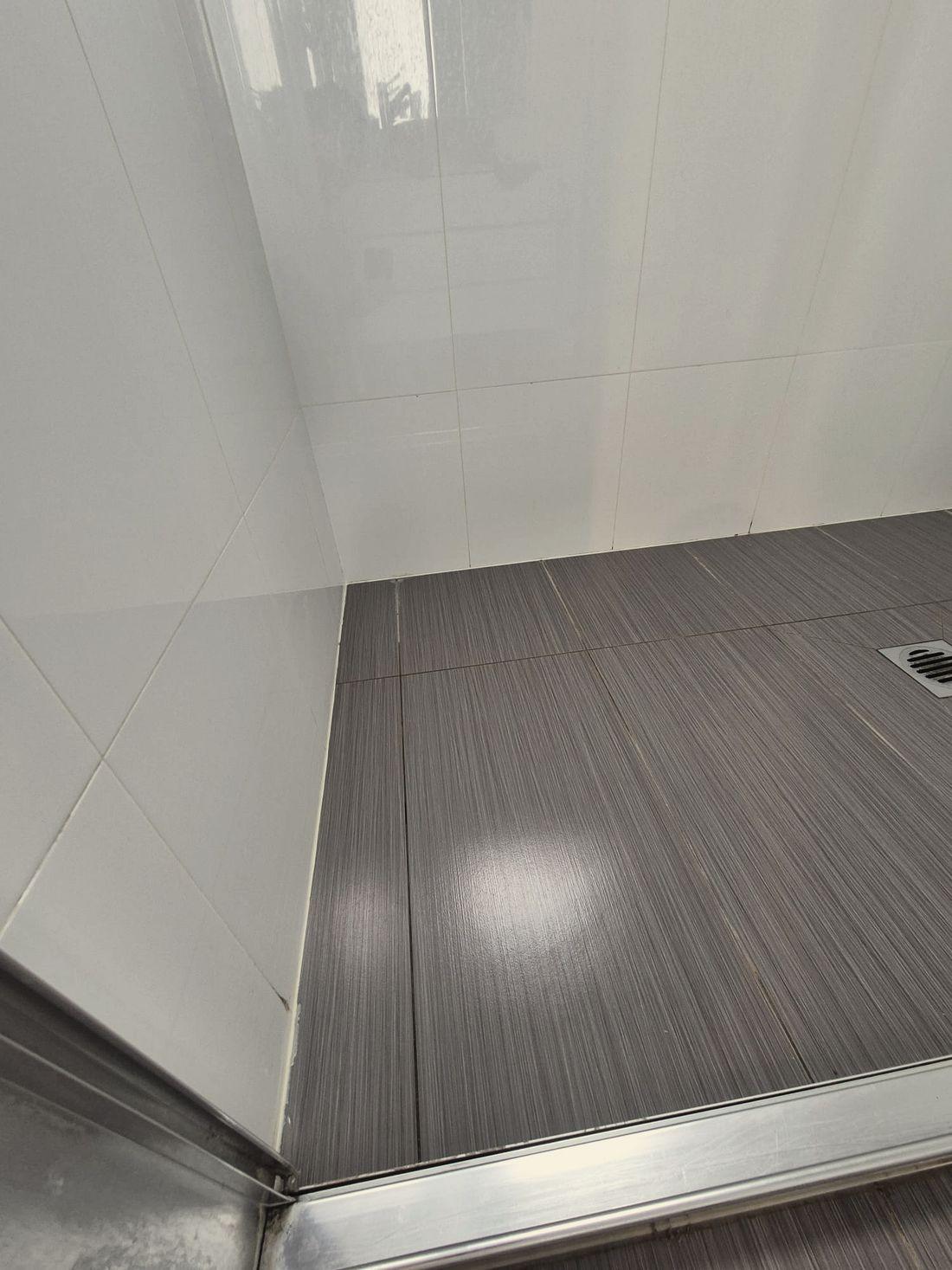 A tiled wall and floor junction detail